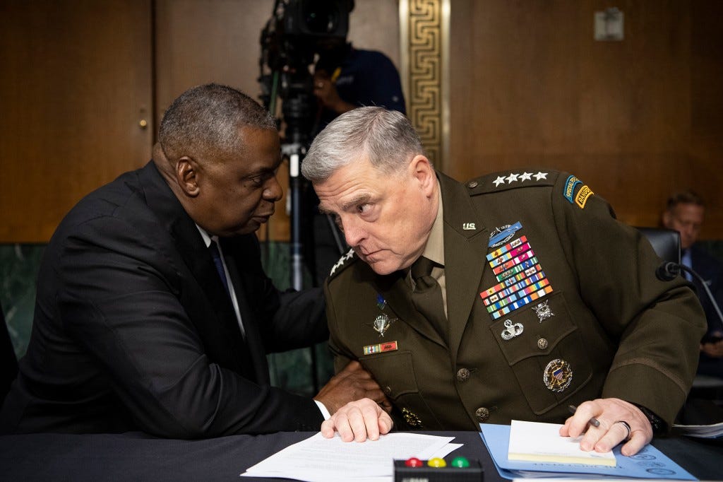 Secretary of Defense Lloyd Austin, left, and Chairman of the Joint Chiefs of Staff Gen. Mark Milley talk before the start of the Senate Appropriations Committee .