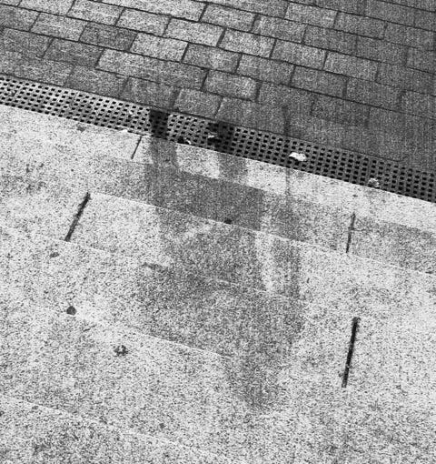 Getty Images A shadow of a person is marked on stone steps