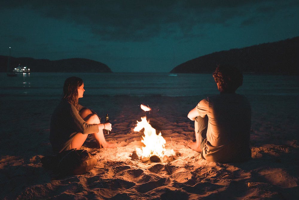 two people on beach at night