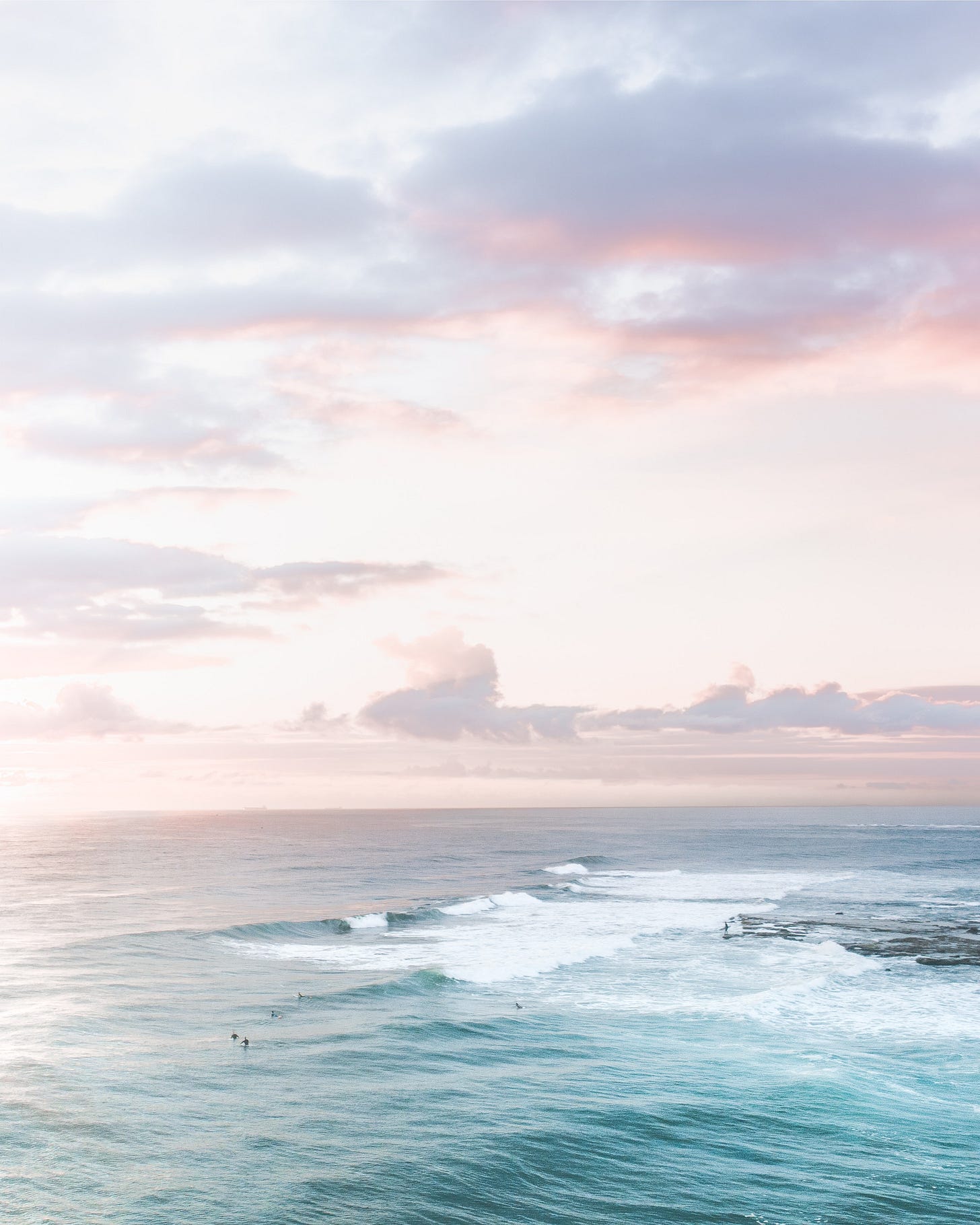 Wavy sea under colorful sky