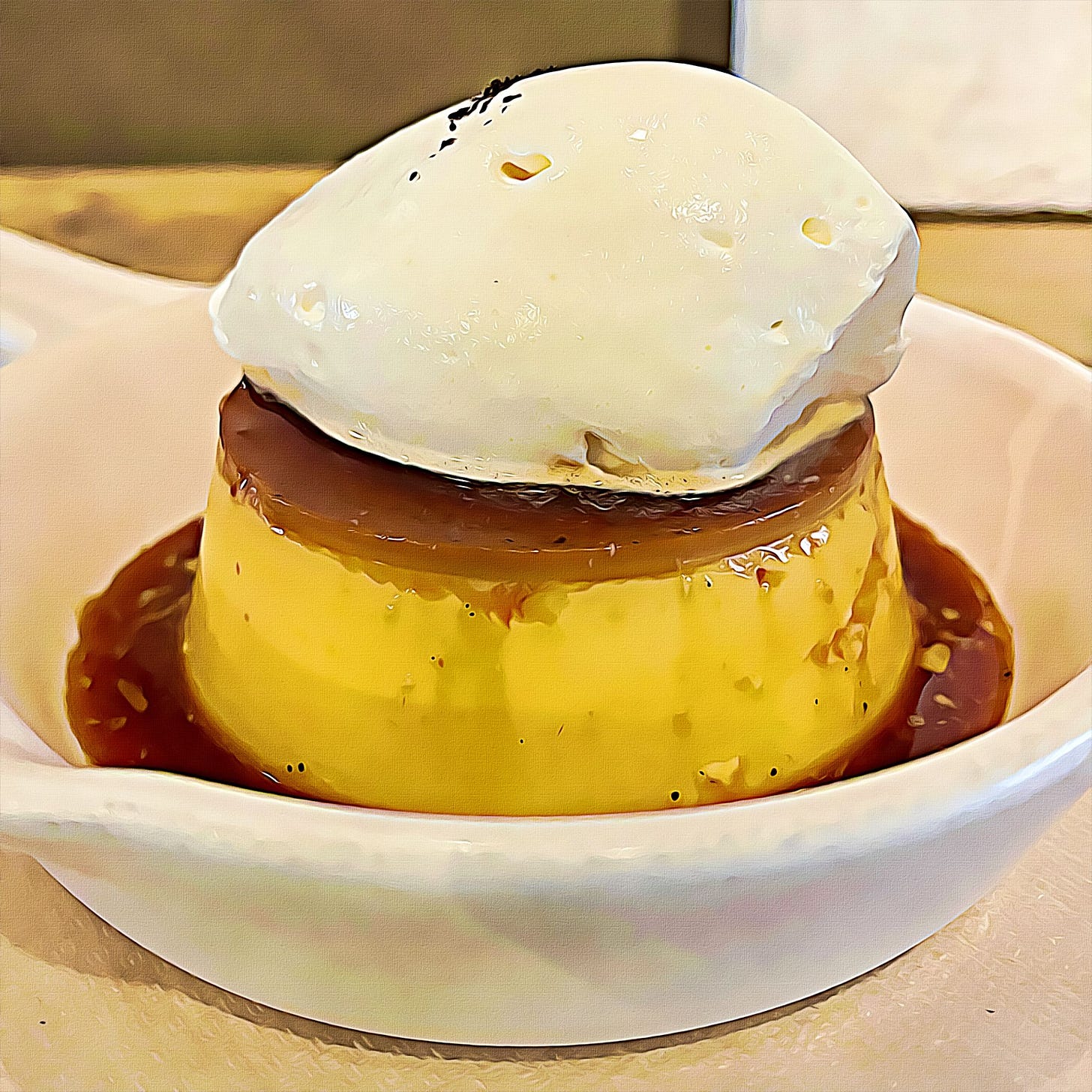 Golden pudding in a white bowl, surrounded in caramel syrup, topped with mascarpone