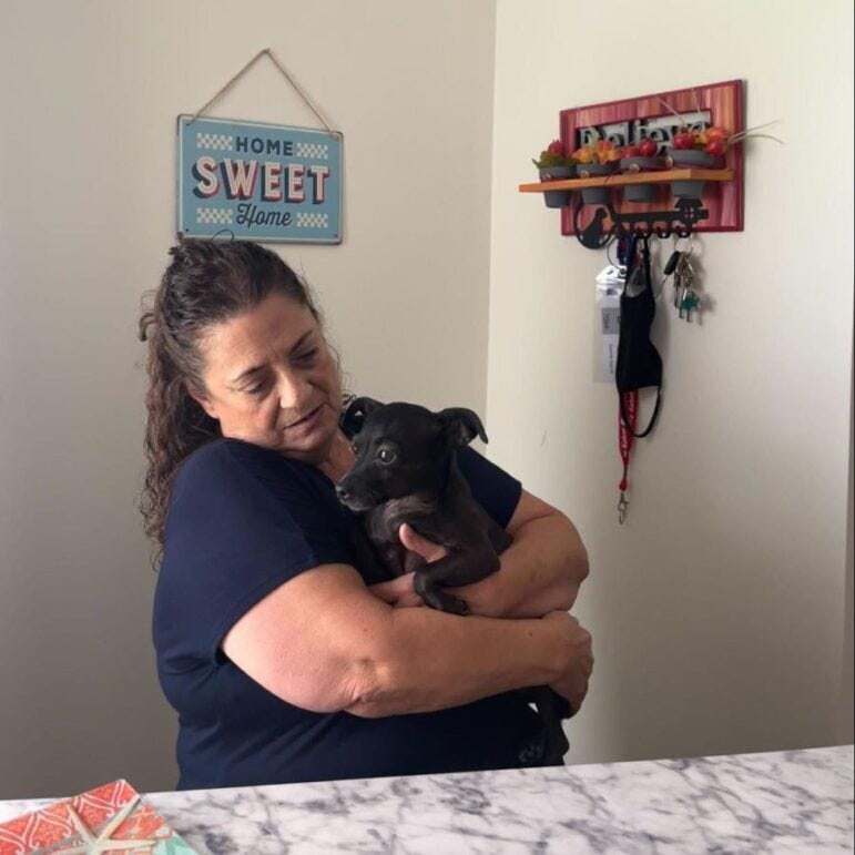 Delores Garcia holds her dog.