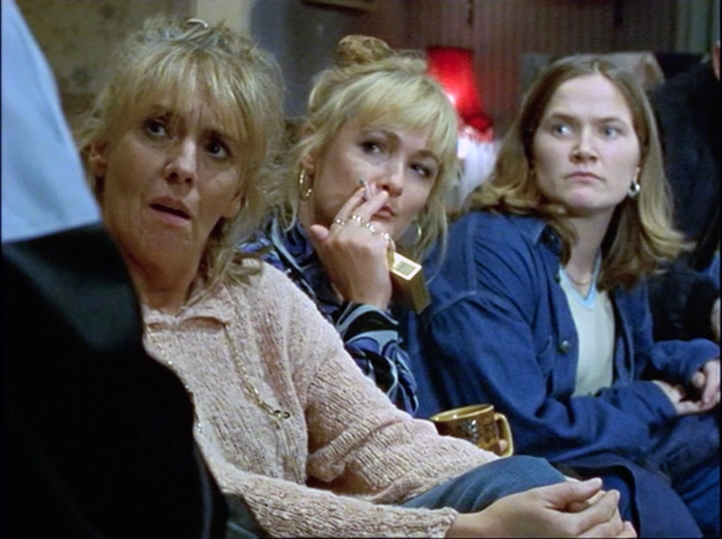 Barbara, Cheryl, and Denise look suspiciously at Twiggy