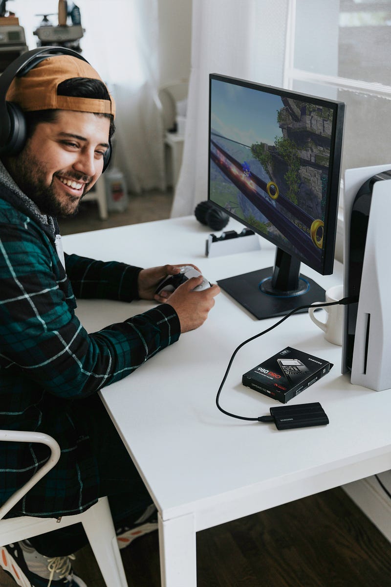 Man sitting at computer and smiling Man sitting at computer and smiling