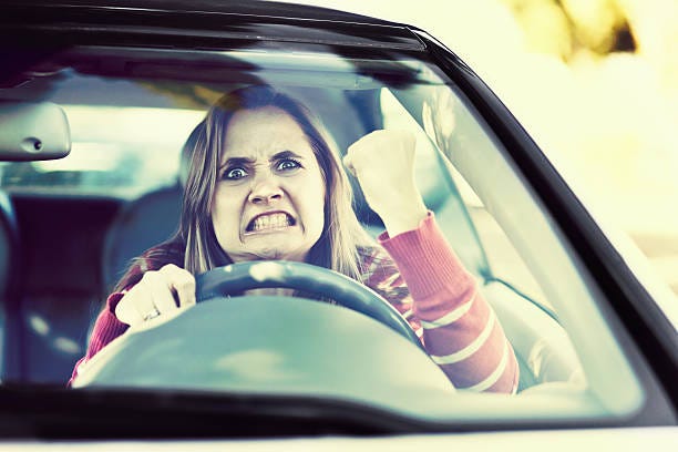 losing her temper, a woman driver shakes fist through windshield - traffic anger stock pictures, royalty-free photos & images