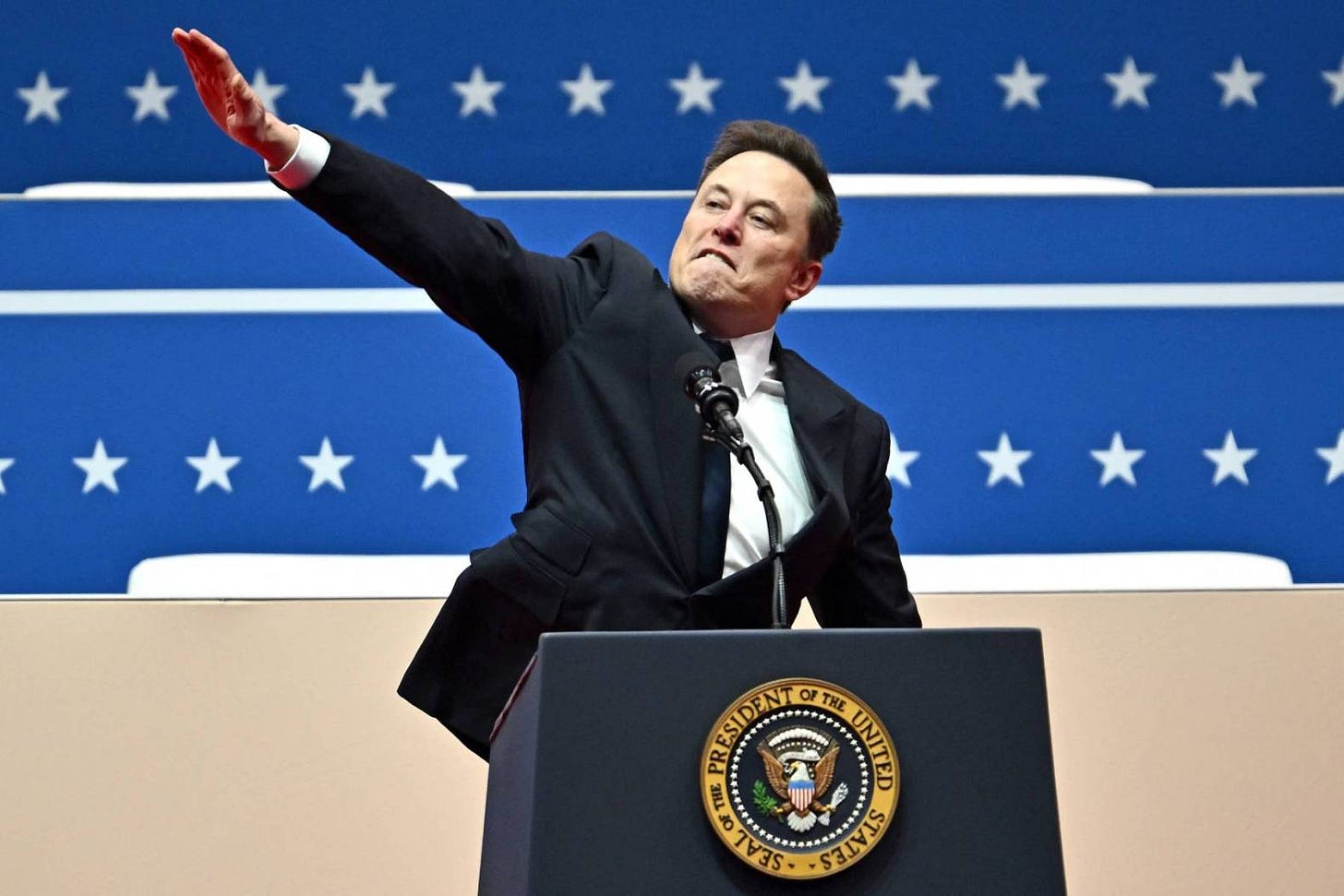 Elon Musk gestures as he speaks during the inaugural parade inside Capitol One Arena, in Washington, DC, on Jan. 20, 2025