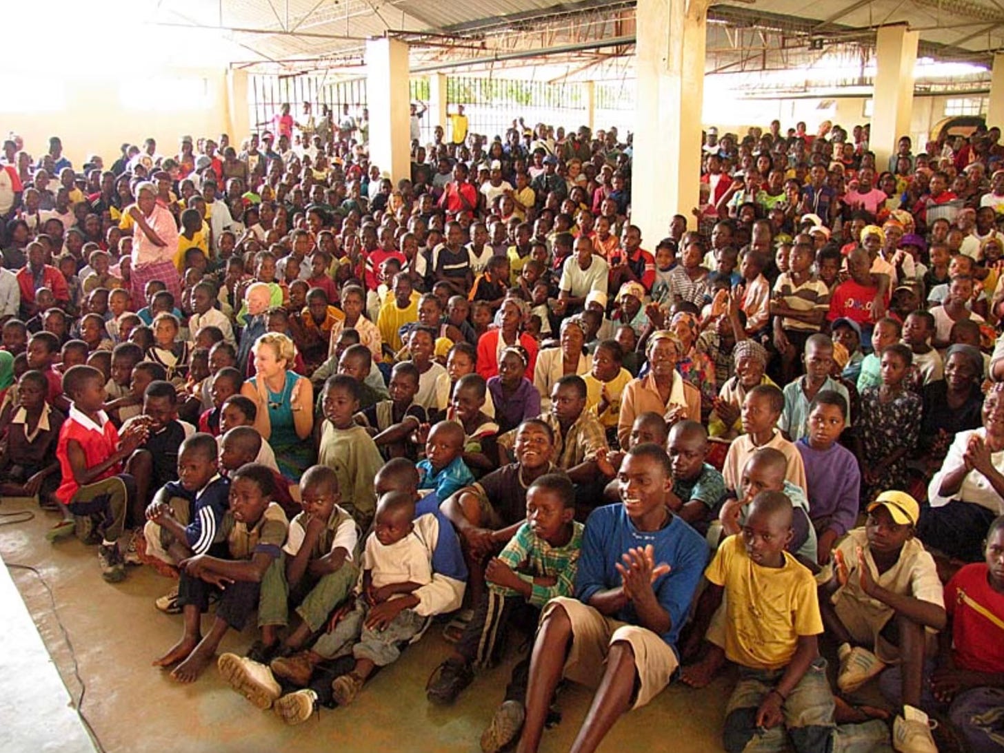 Heidi Baker sitting with hundreds of children in Africa
