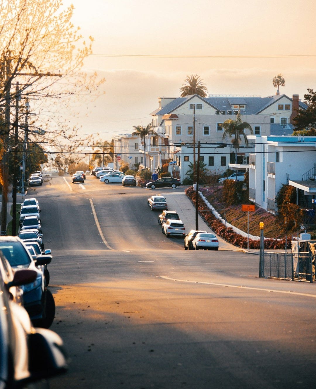 a street with cars parked on both sides of it