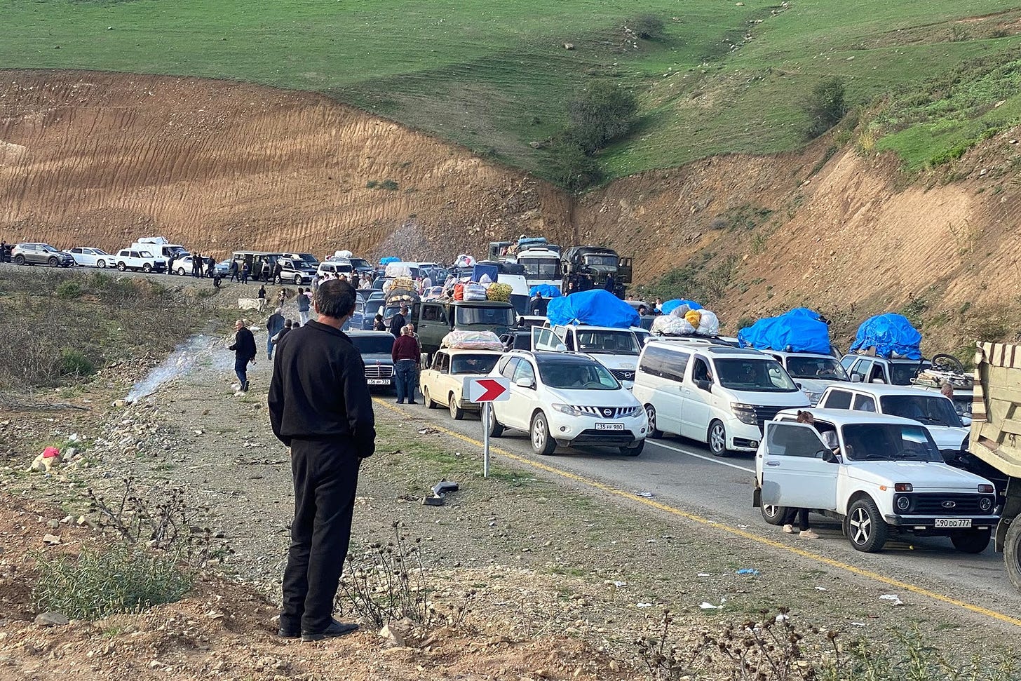 Refugees drive their vehicles in Nagorno-Karabakh.