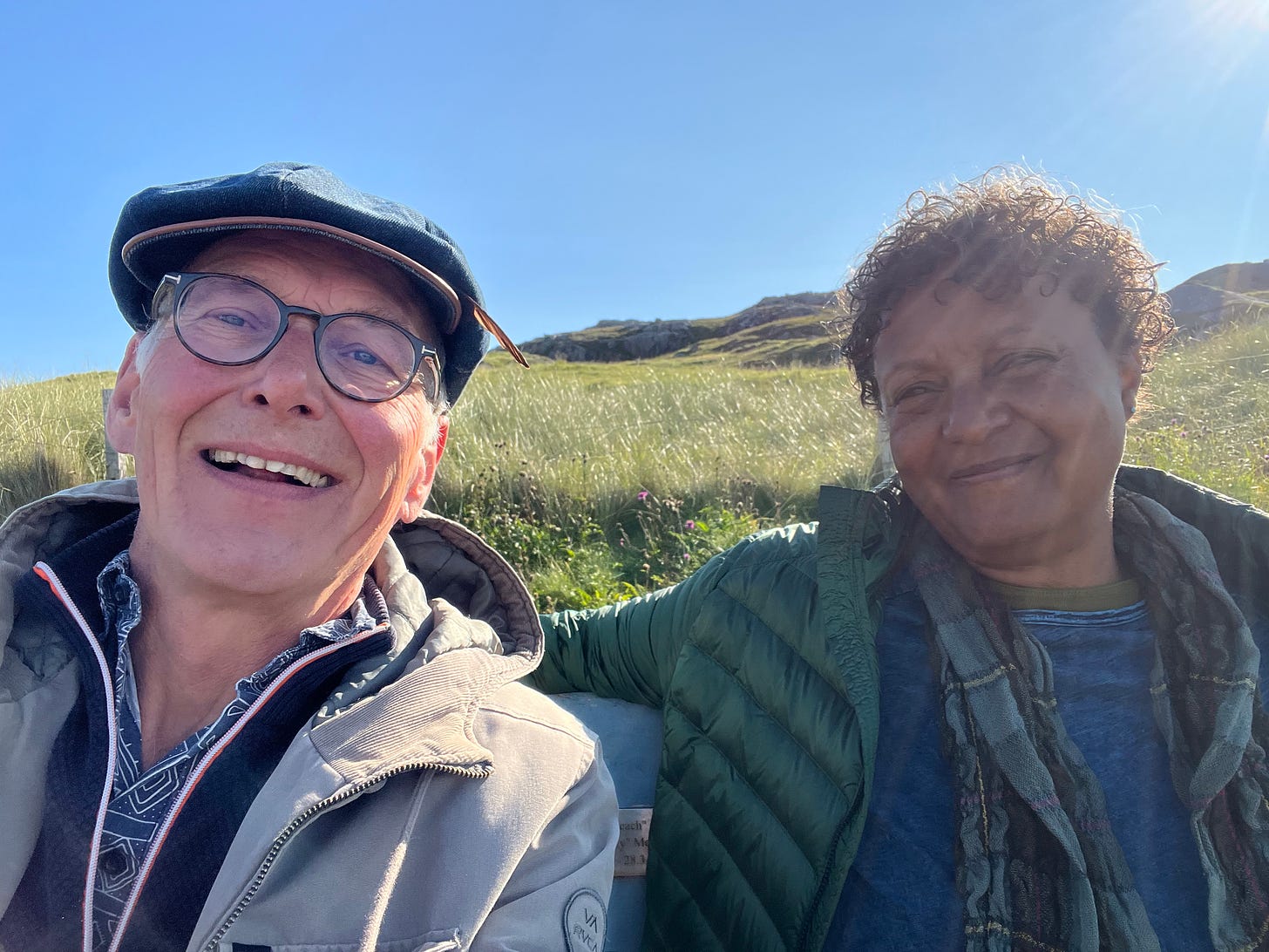 My companion and I rest on a bench in the sunshine, well wrapped in jackets and sweater