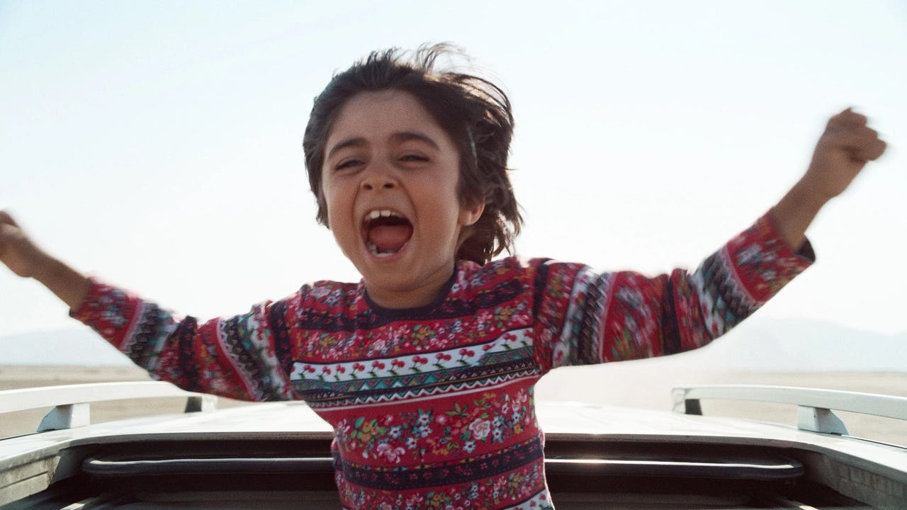 Rayan Sarlak as Little Brother in Panah Panahi's 2021 Iranian comedy/drama Hit the Road