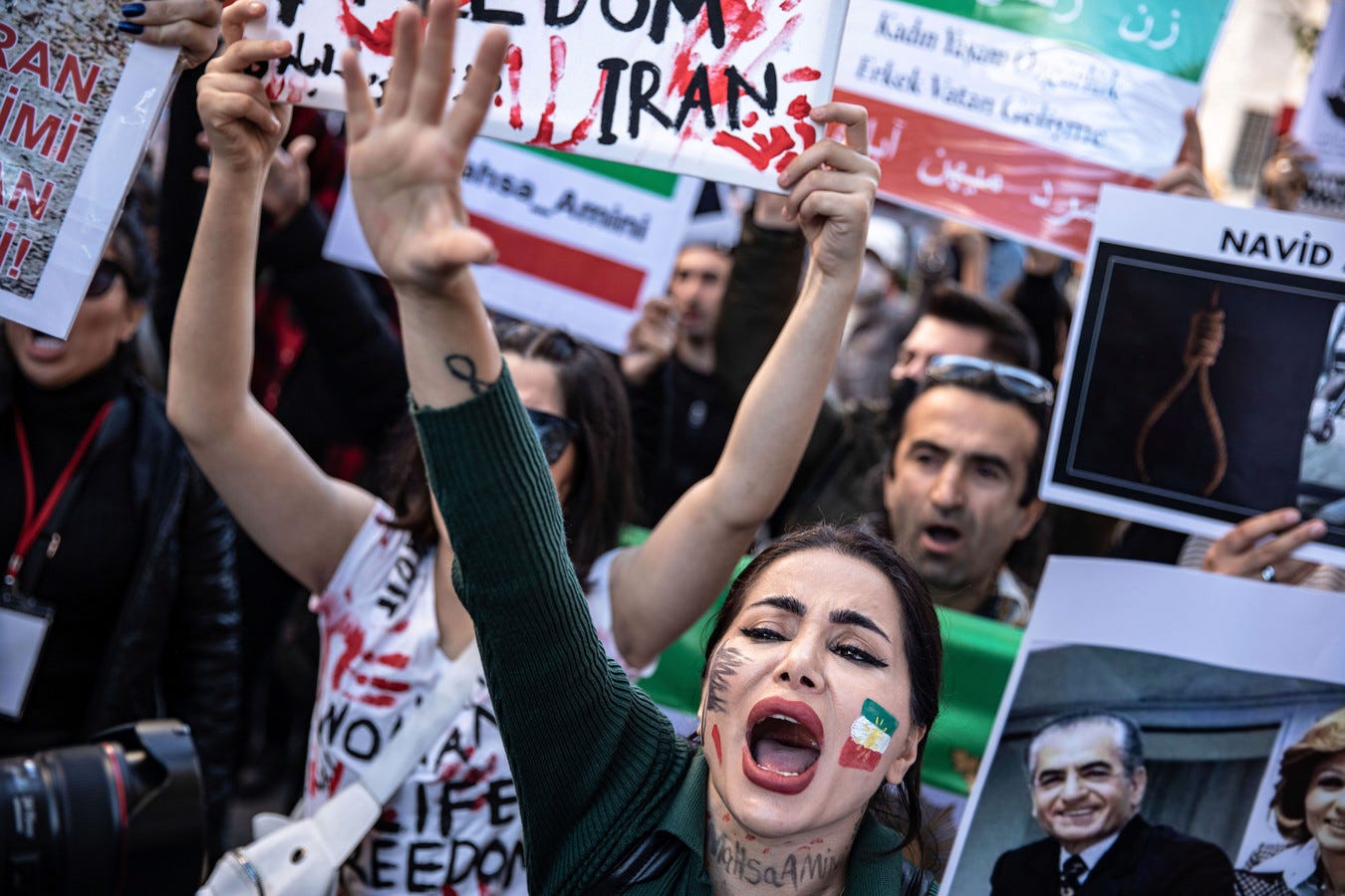 Protesters hold placards while chanting slogans outside the Iranian Consulate in Istanbul during the demonstration.
