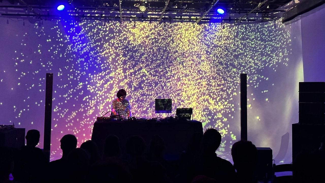 Jo Johnson performing at a Mysteries of the Deep event in Brooklyn. Visuals by Candace Price. Photo by Grant Aaron.