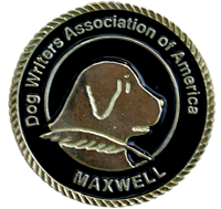 Gold medal with black background and words Dog Writers Association of America Maxwell Medallion