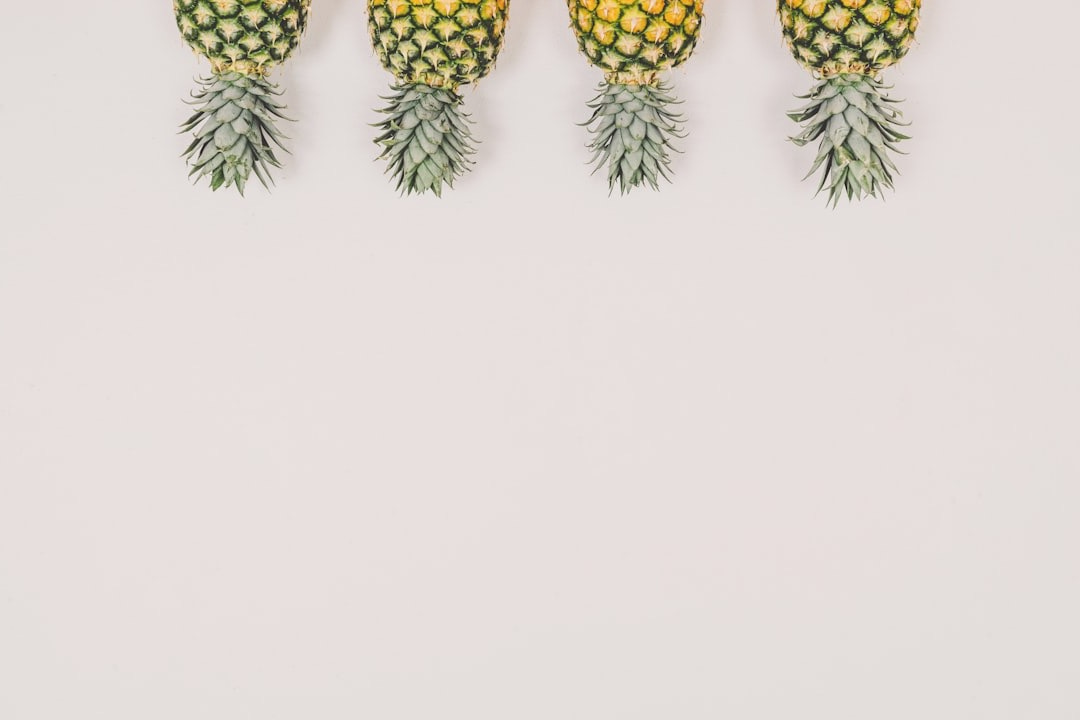 four pineapples on white background four pineapples on white background