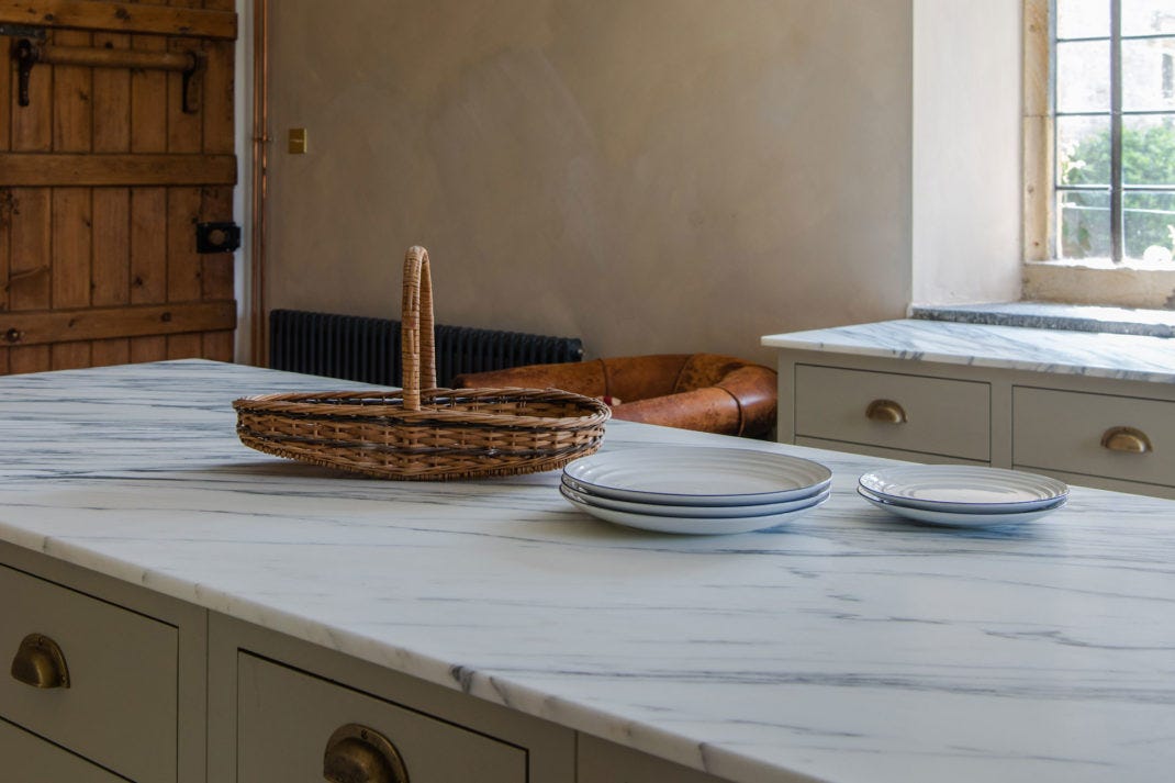 a close up view of a marble island in a kitchen by Plain English, by British Standard