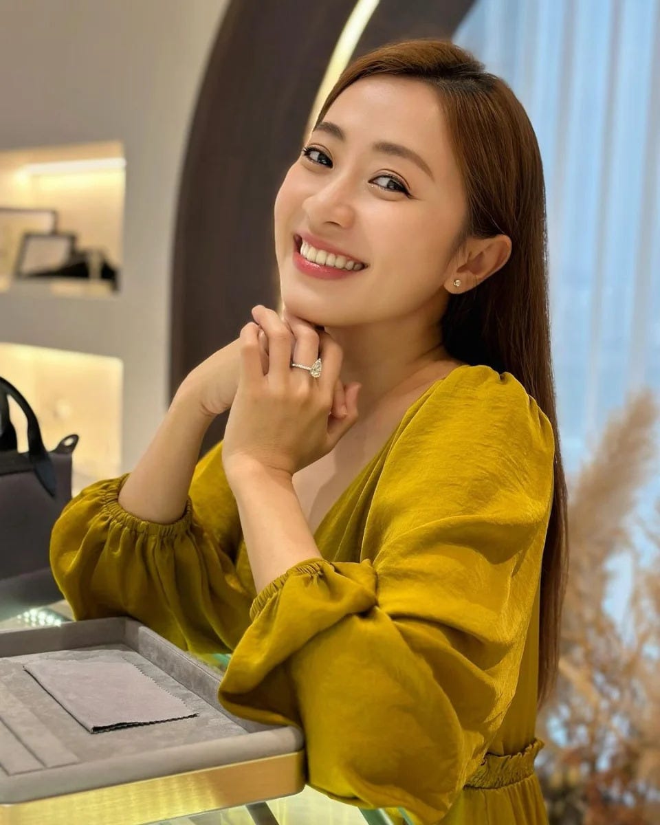 Queenzy Cheng smiling in a golden top.