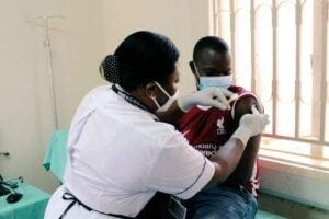 The first PrEPVacc volunteer participant receives an injection at the launch of the launch of the PrePVacc Trial at the Masaka site of the MRC/UVRI and LSHTM Uganda Research Unit, on Tuesday 15 December 2020.