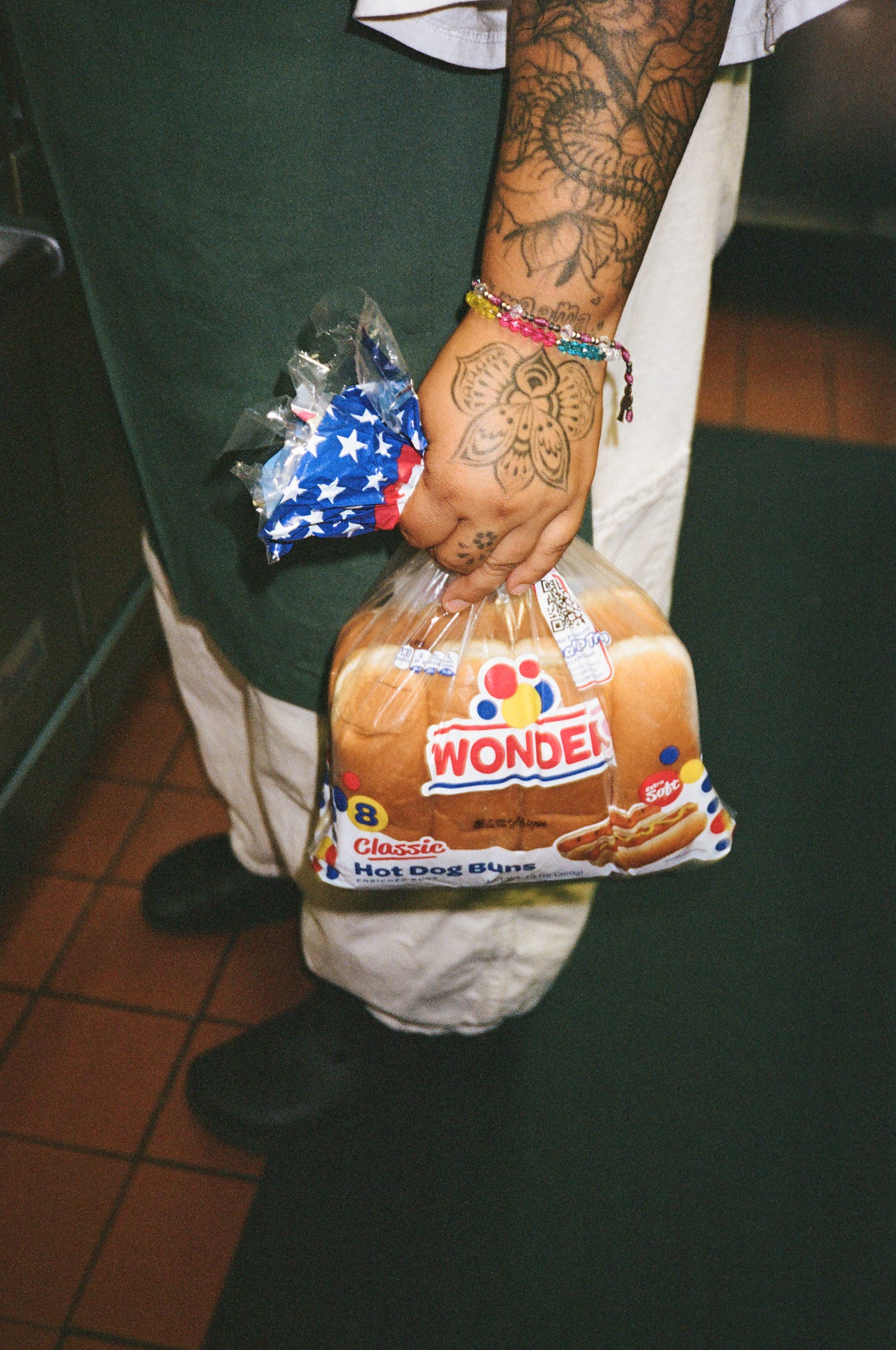 The Ruby Fruit sous chef Agua Lemus holds Wonder buns