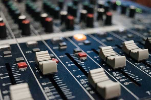 A close-up of white dials on a music mixer A close-up of white dials on a music mixer
