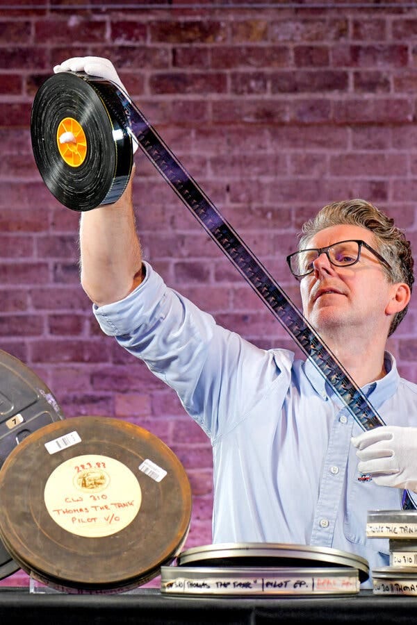 guy stretching a film strip
