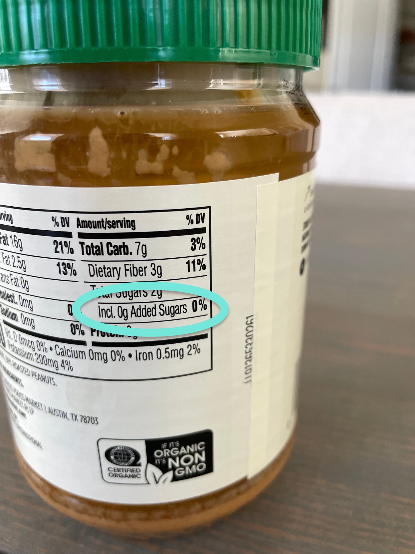 Peanut butter container highlighting added sugar at zero percent daily value