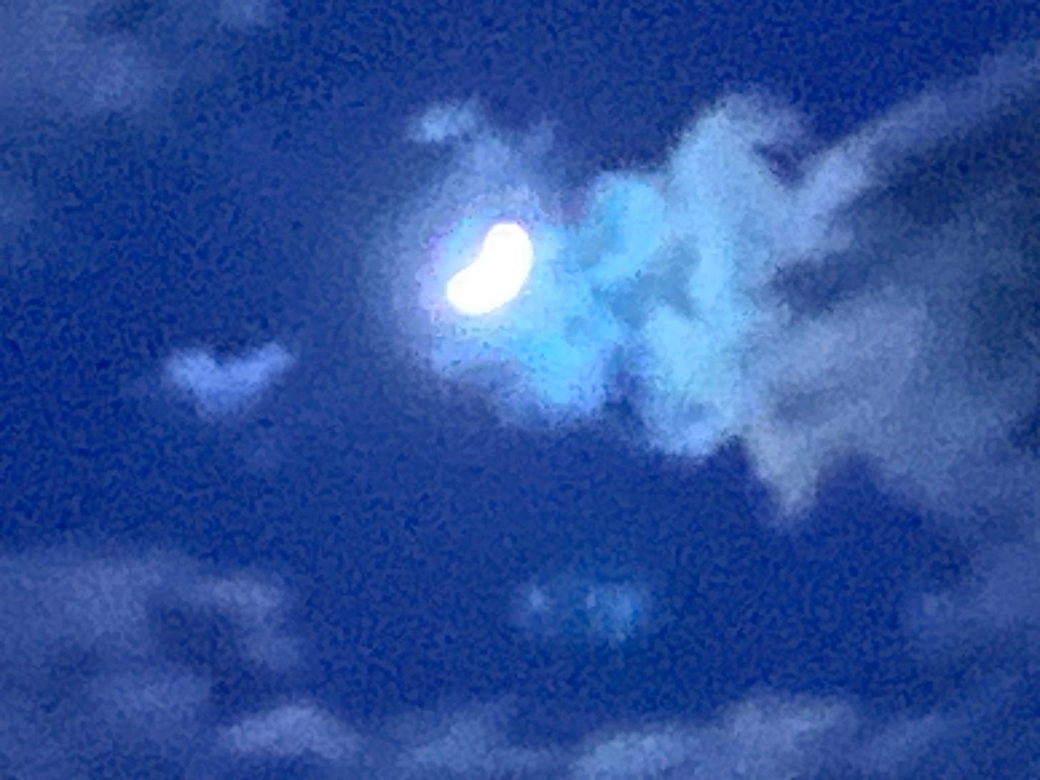 A grainy and pixilated view of the moon as a bright white blurred crescent n a strangely intense dark blue sky. The moon illuminates clouds which stream away like a scarf blown in the wind.