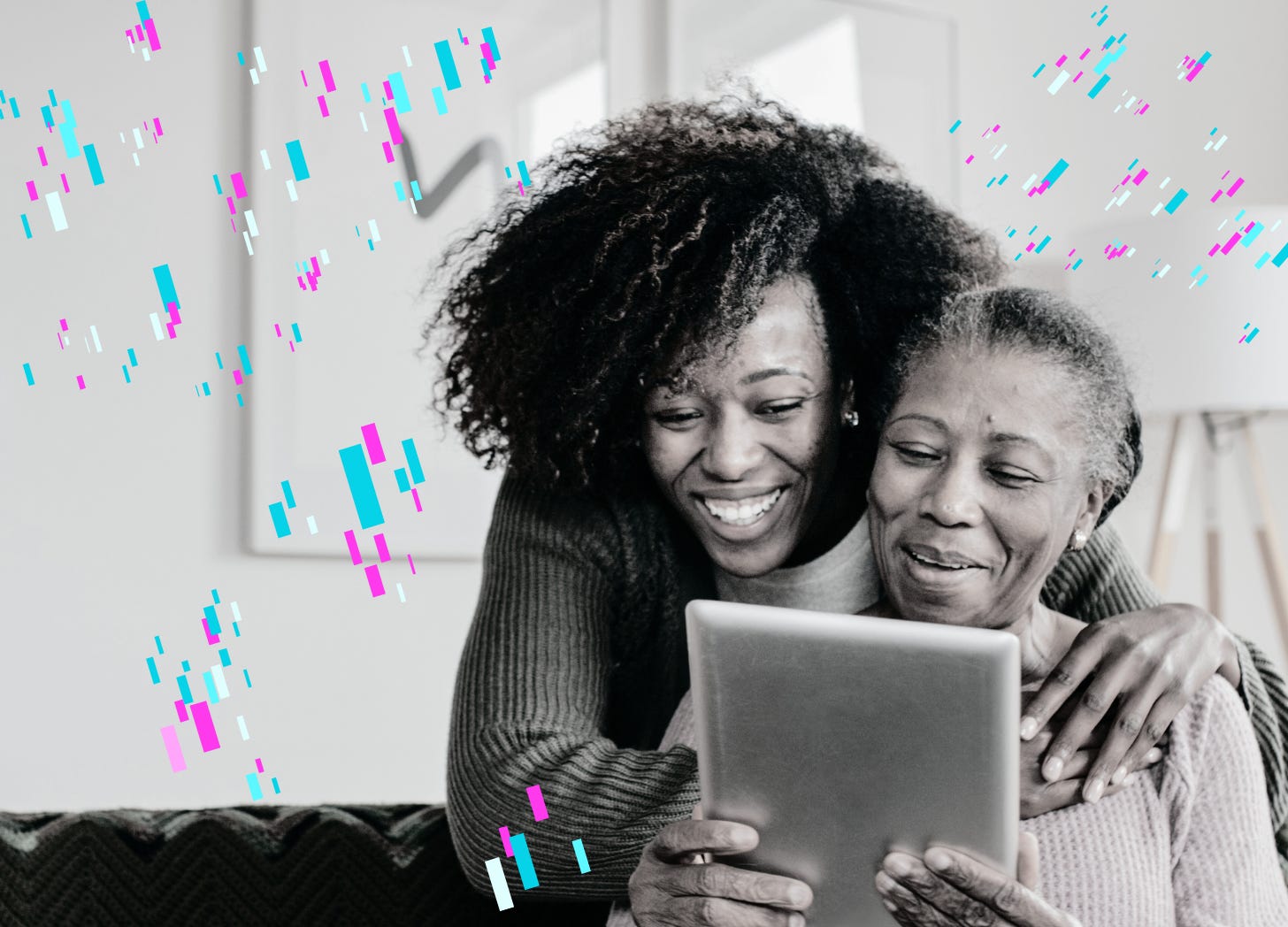 Woman hugging older women and looking over her schoulder at an iPad