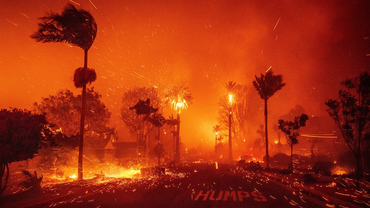 The Palisades Fire ravages a neighborhood amid high winds in the Pacific Palisades neighborhood of Los Angeles, Tuesday, Jan. 7, 2025.