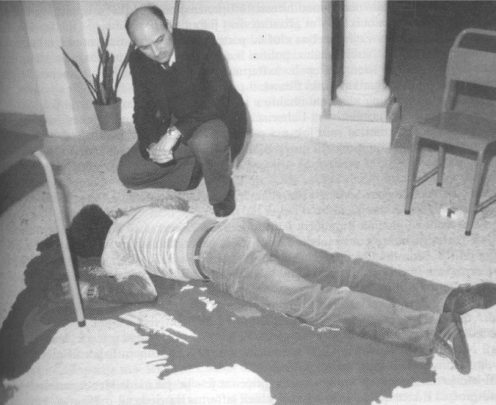 The height of the violence, PN MP Louis Galea looks on the body of Raymond Caruana in a pool of his own blood