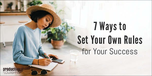 Woman writing in a notebook. Text overlay: 7 Ways to Set Your Own Rules for Success