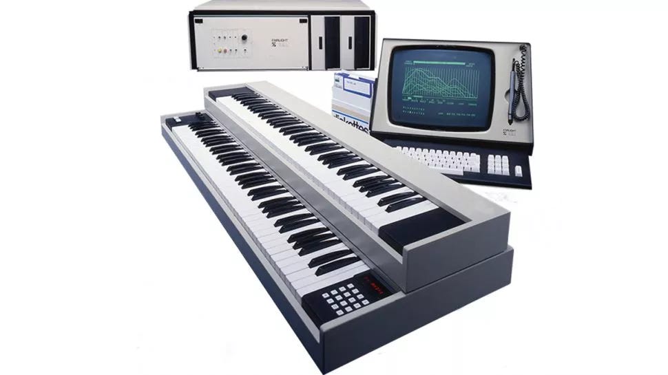 An old Fairlight CMI Sampler from the 80s showing two stacked keyboards, a separate unit featuring a combined computer screen and keyboard, as well as the processing module that kind of looks like a big PC tower on its side.