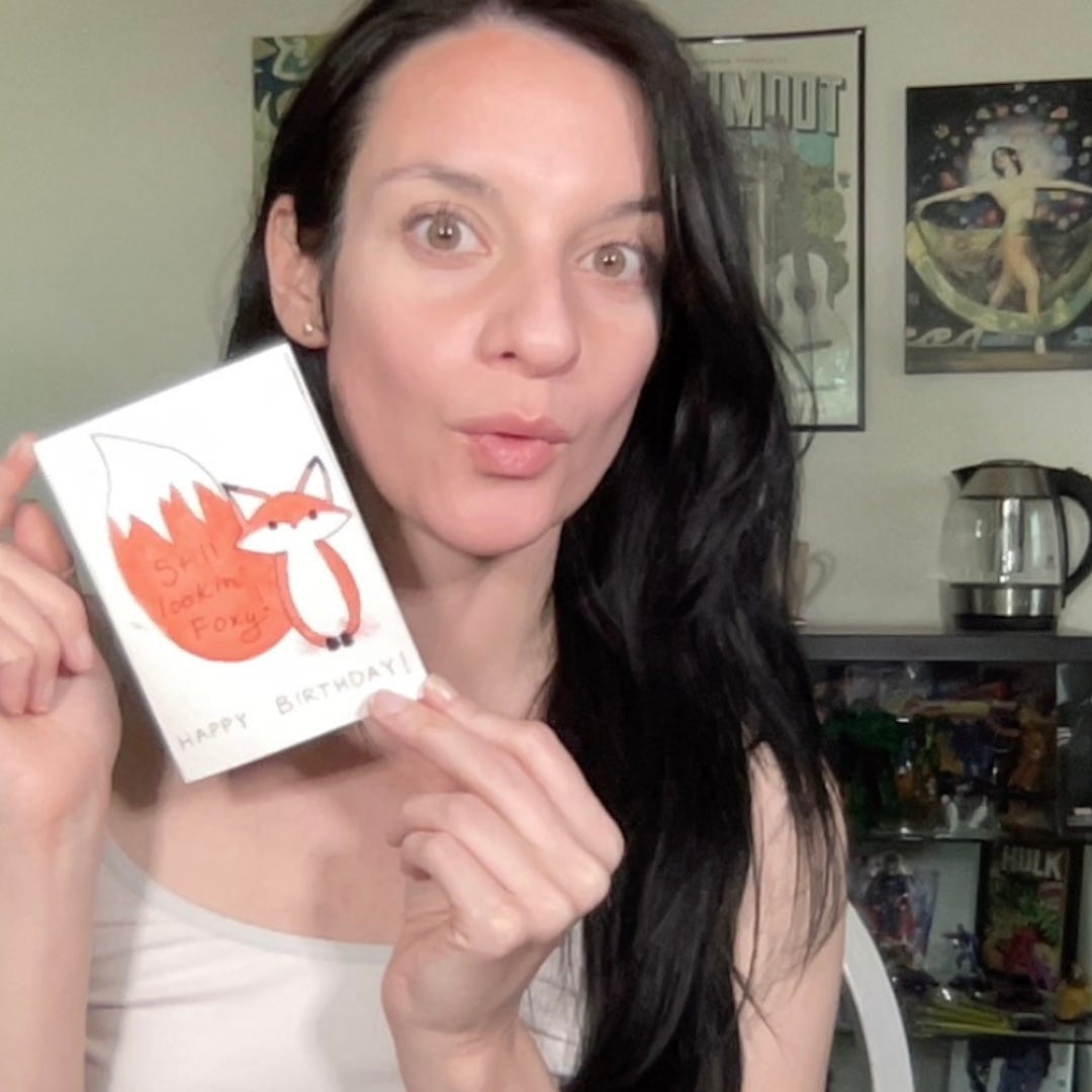 Woman holding painted fox card.