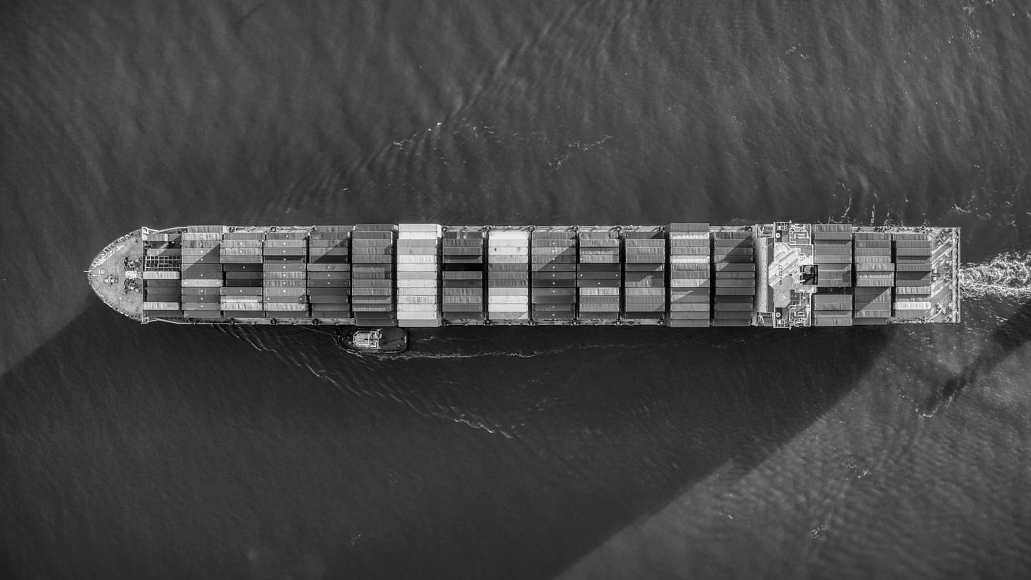 A birds eye view of a cargo ship in the ocean