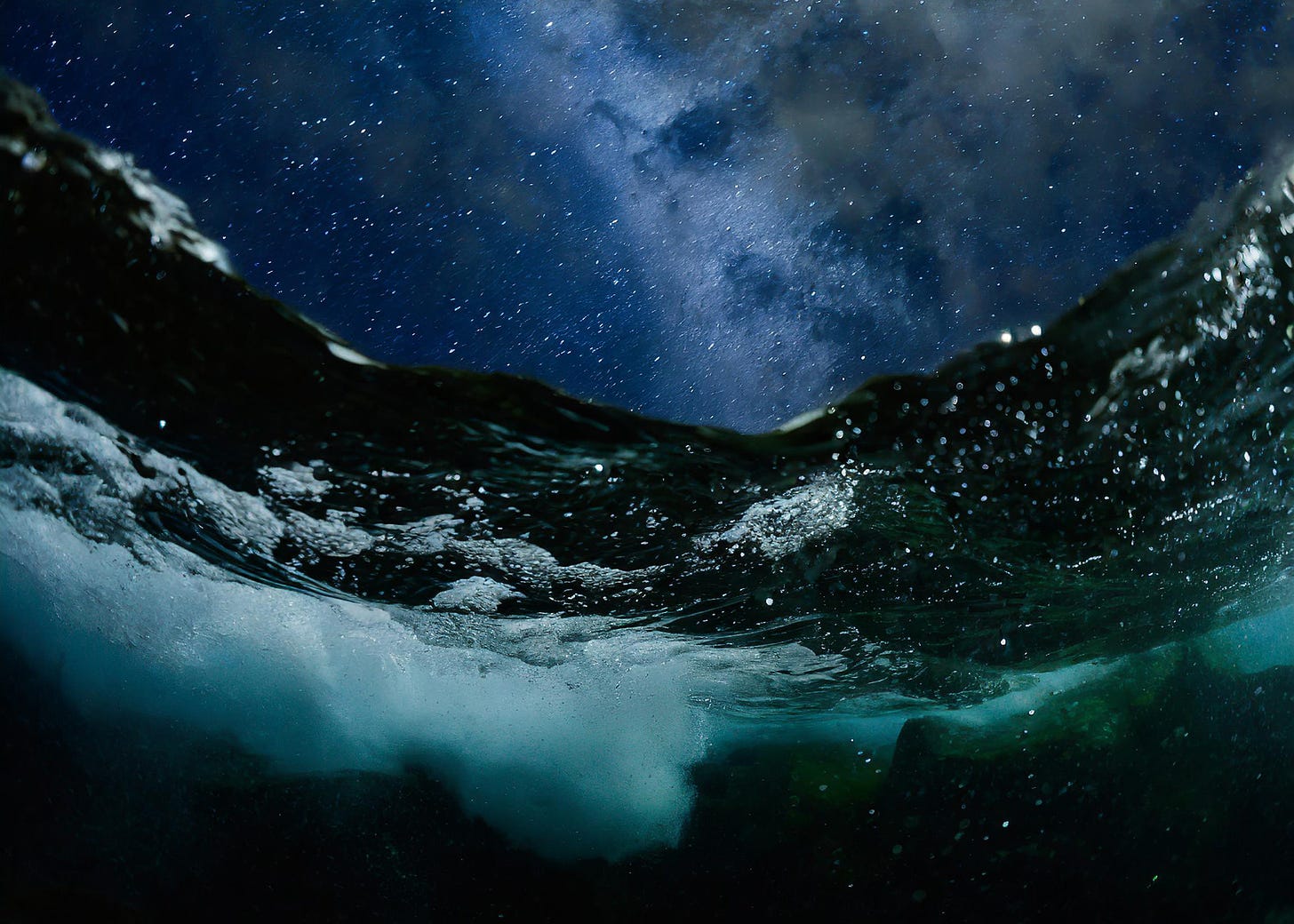 night view from beneath stormy ocean looking up at surreal starry sky
