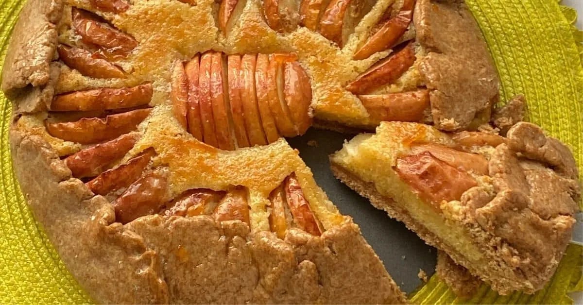 Cutting a slice of apple frangipane tart.