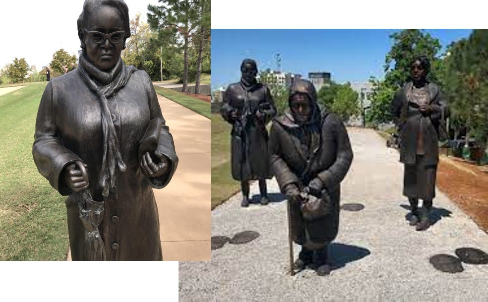 A statue of a person in a park

Description automatically generated