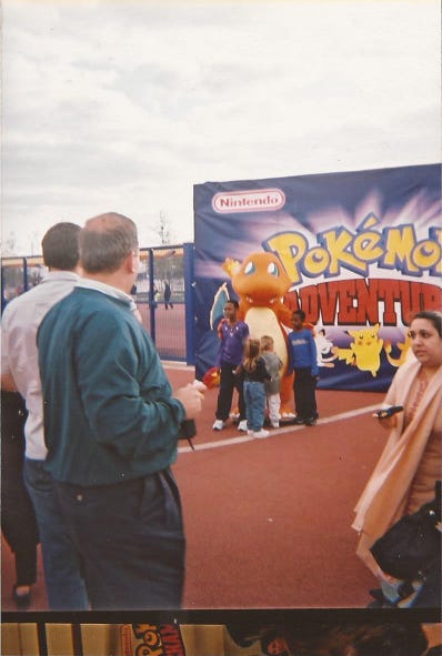 A photograph of children posing with Charmander
