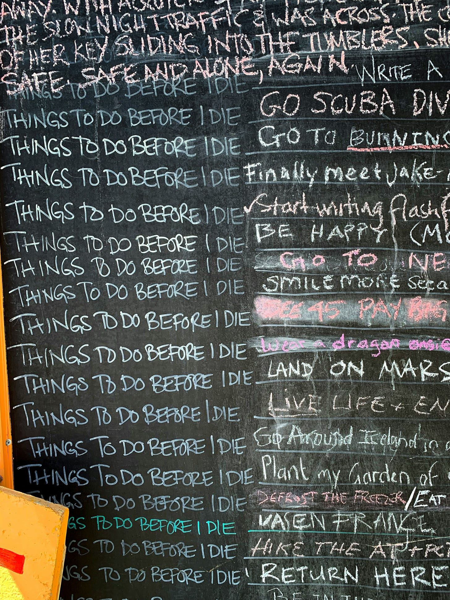 Lists on a chalkboard, including lots of "things to do before I die"