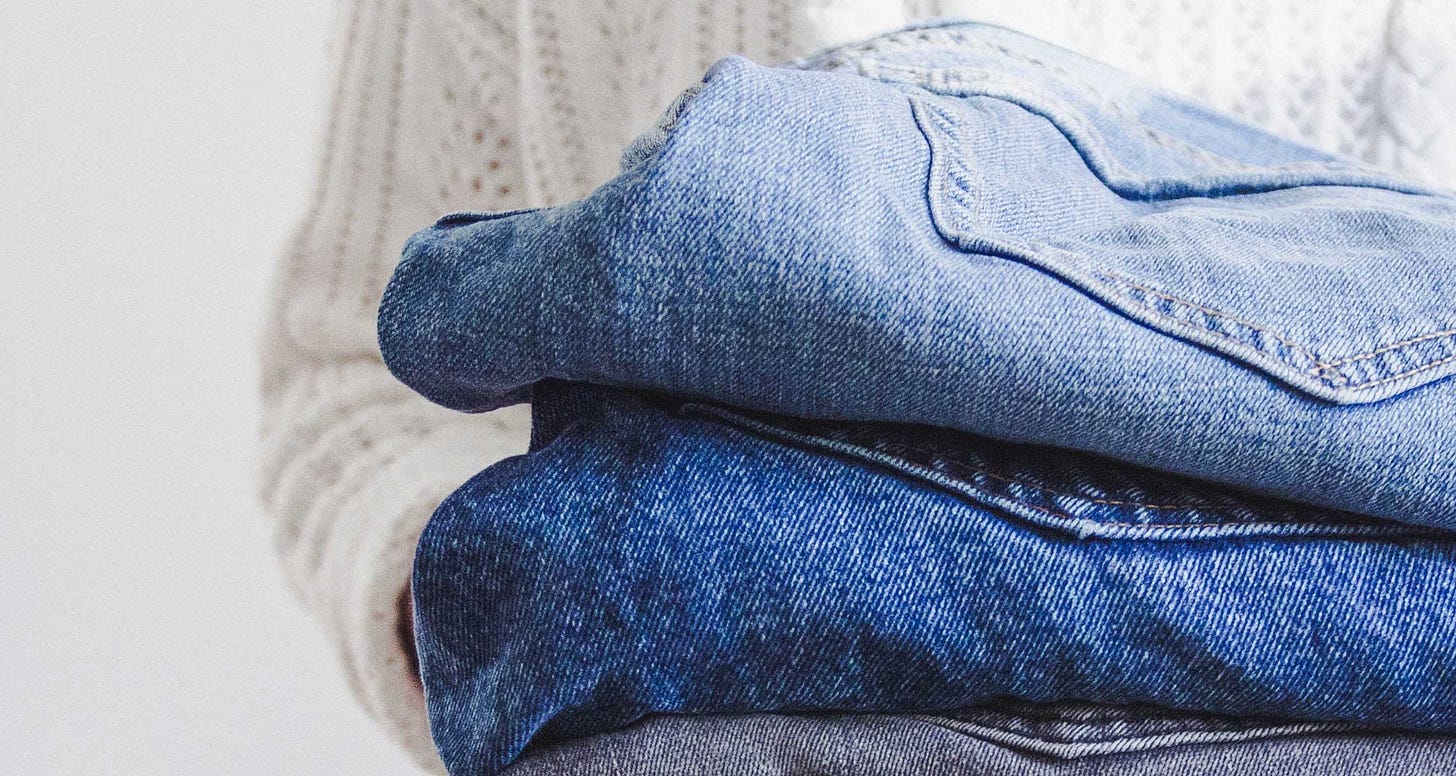 Stack of folded pairs of jeans.