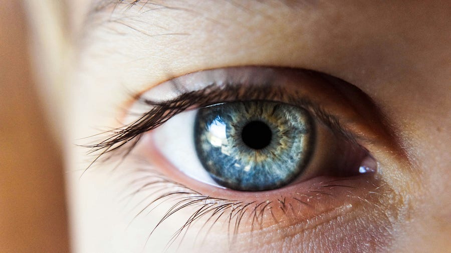 The blue eye of a person looking at the camera.