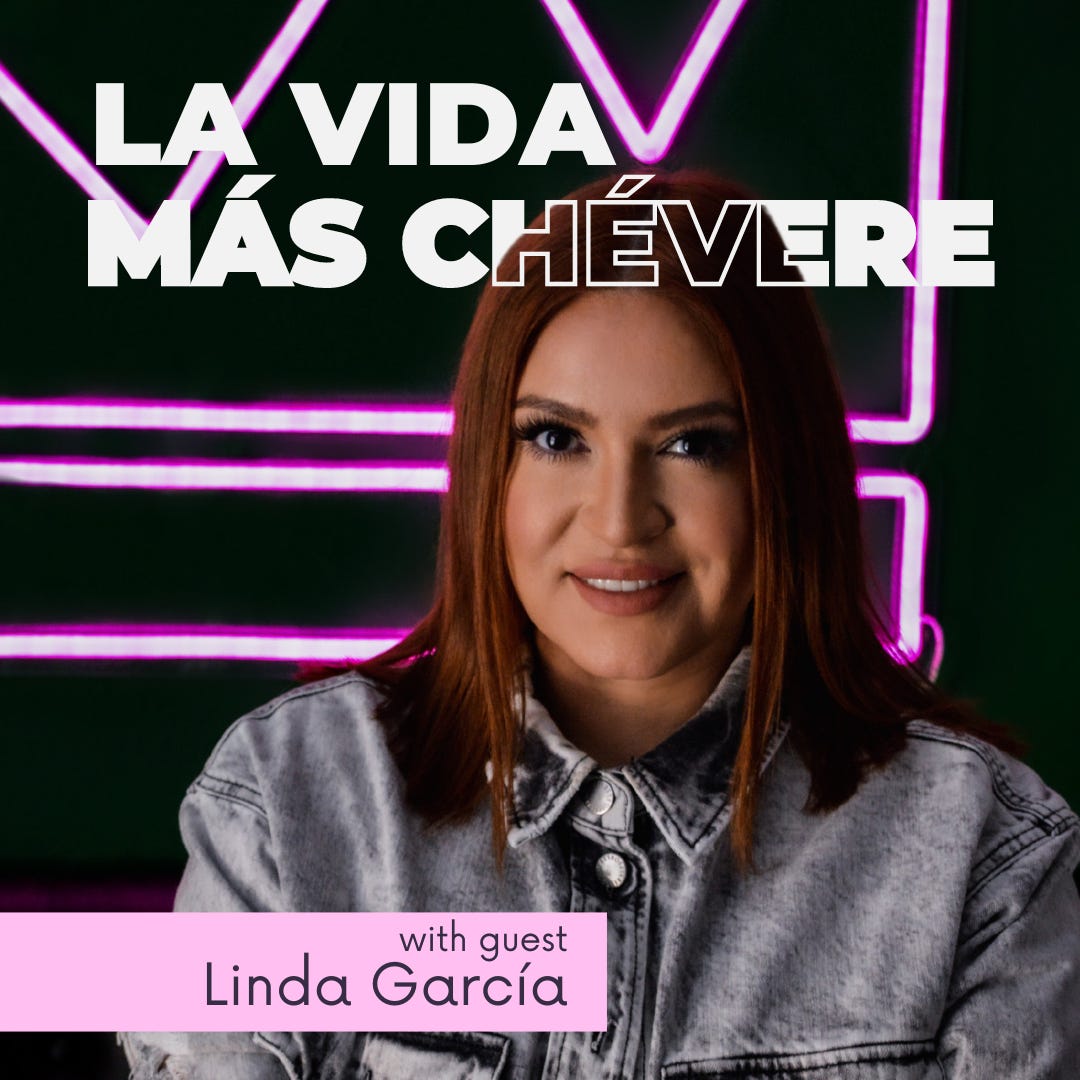 Linda in a denin jacket posing in front of a large pink neon crown with La Vida Más Chévere and with guest Linda Garcia text overlaid