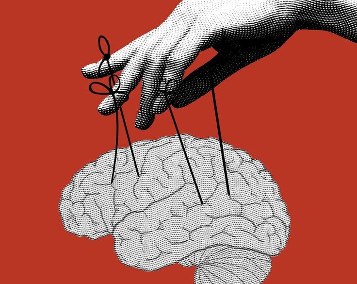 This may contain: a hand holding pins in the shape of a human brain on a red background with black and white lines