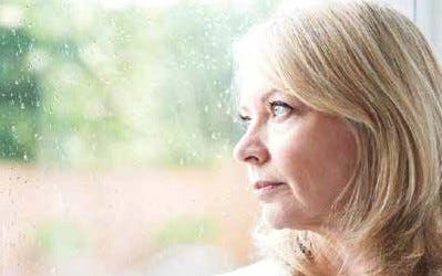 woman looking out window