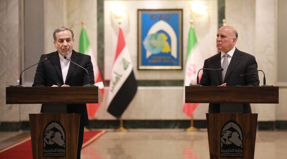 Iranian Foreign Minister Abbas Araghchi (L) and his Iraqi counterpart Fuad Hussein attend a joint press conference in Baghdad on October 13, 2024. (Photo by AFP)