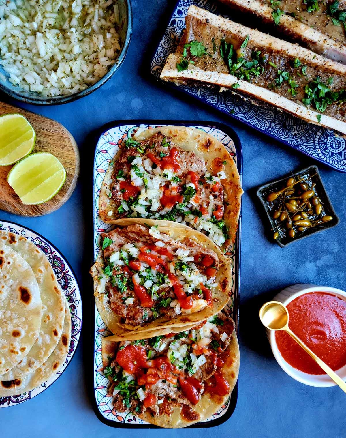 A big spread of tacos and bone marrow, Mexican style. 
