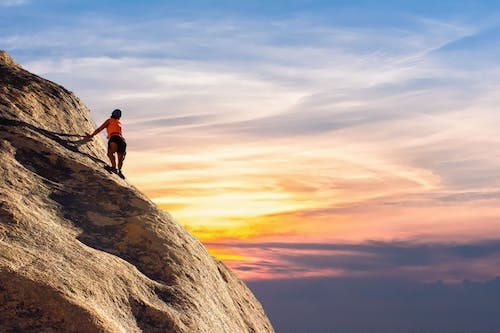 Free Person Climbing on Mountain Stock Photo