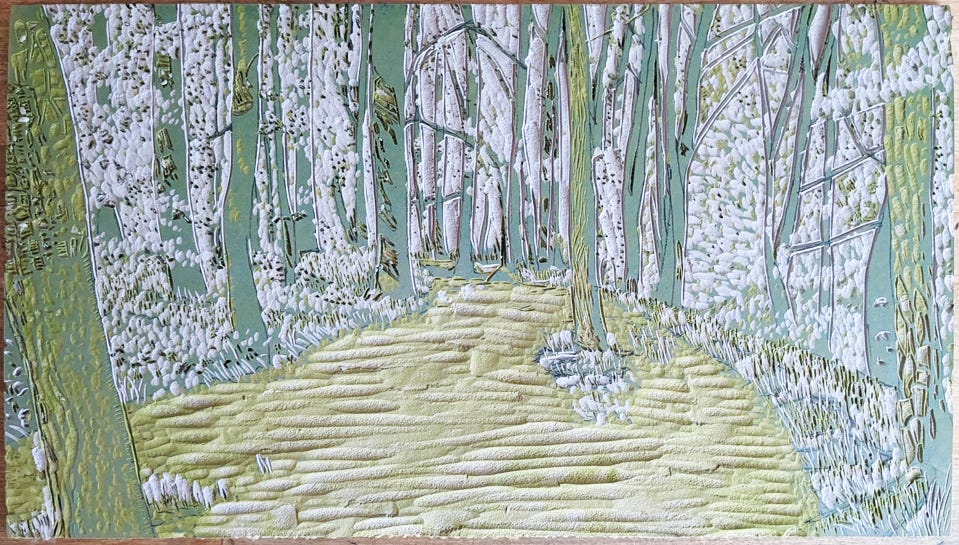 A carved block of lino with an image of trees