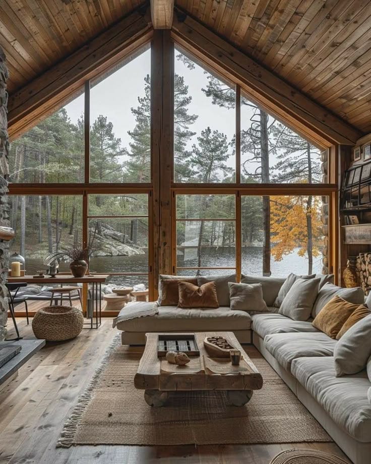 This may contain: a living room filled with lots of furniture next to a large window covered in wood