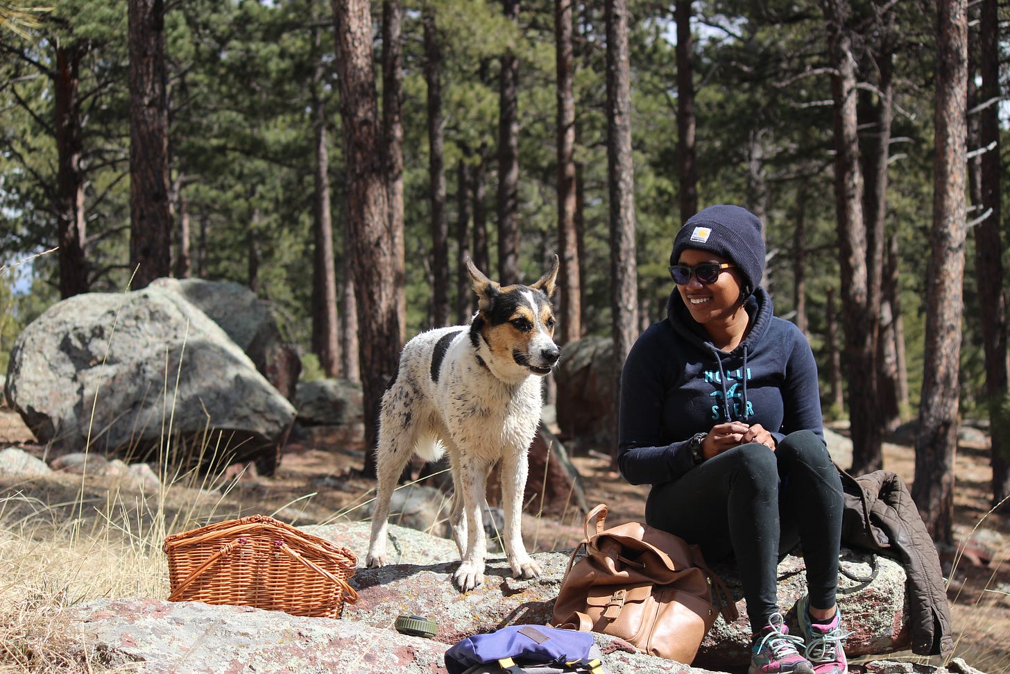 Me, sitting on a rock in Boulder, Colorado with my dog Leia. We are deep in the woods enjoying a special moment together